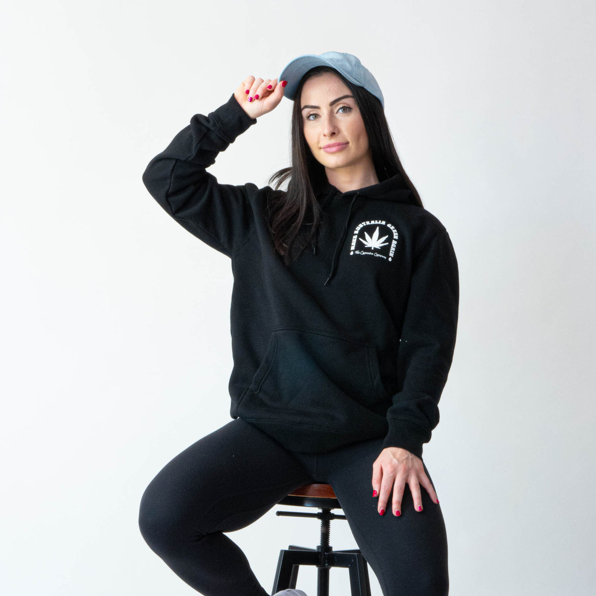 Girl wearing Green Altar Black Cotton Hoodie seated on chair