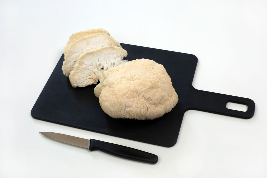 Sliced Lions mane mushroom on cutting board