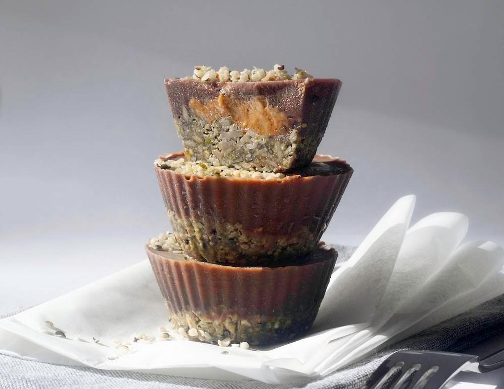 Stacked cupcakes with base nuts and chocolate on top