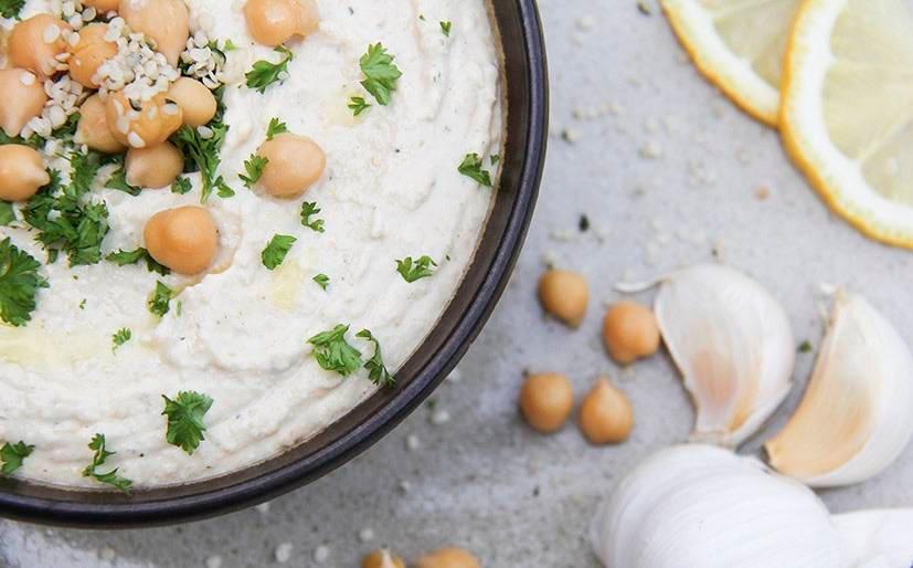 Hummus in a bowl topped with chickpeas